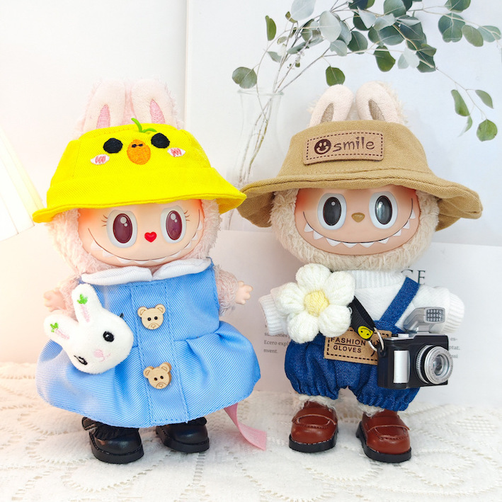 Two dressed dolls with bright hats and tiny accessories