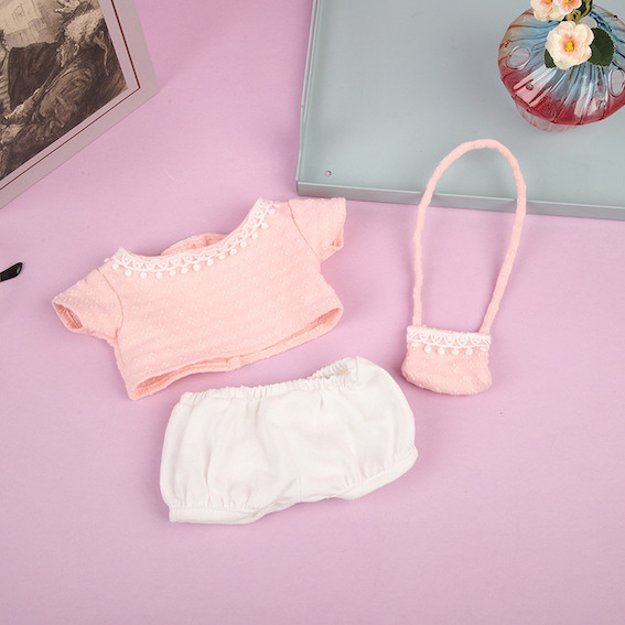 Pink doll top, white shorts and a tiny shoulder bag